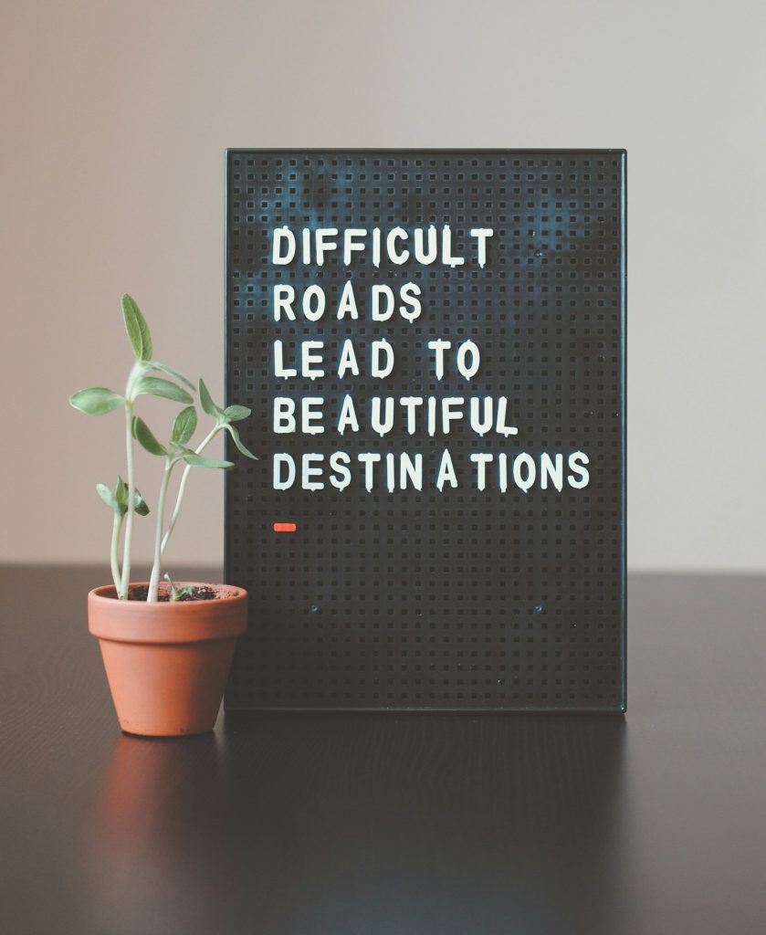 sign that reads: difficult roads lead to beautiful destinations